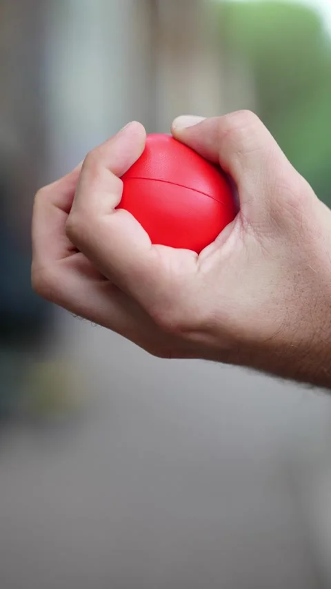 Man's Hands Using Stress Ball for Relaxation Видео 293344357