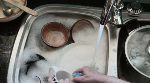 Man's hands washing dishes in kitchen sink. Stock Footage