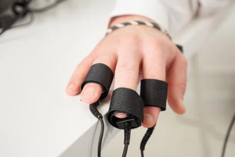 Man's hands on which polygraph sensors are worn Stock Photos