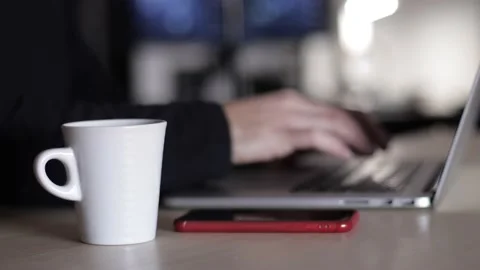 Man's hands work on laptop in the office having a cup of tea or coffee. Closeup  Video stock 149293704