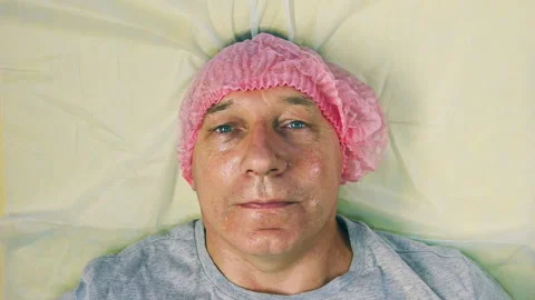 The man's head is lying on the cosmetic couch. Stock Footage 96034182