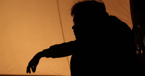Man’s Head Silhouette in Yellow Light 스톡 동영상 335433347