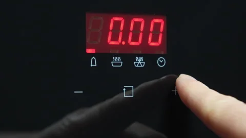 A man's index finger sets a timer on an oven. Stock Footage 305659081