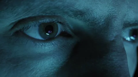 Mans Intense Eyes Reflecting Computer Screen In A Dark Room Stock Footage 329967786