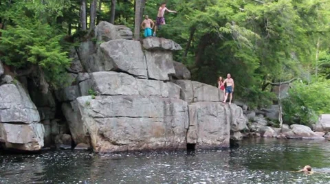 Mans jumps off cliff into water Stock Footage 46090715