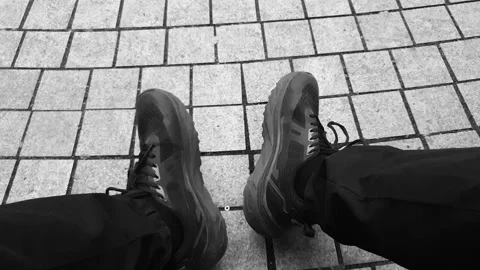A man's legs POV in athletic shoes and pants. The man is crouching bench POV Stock Footage 344346366