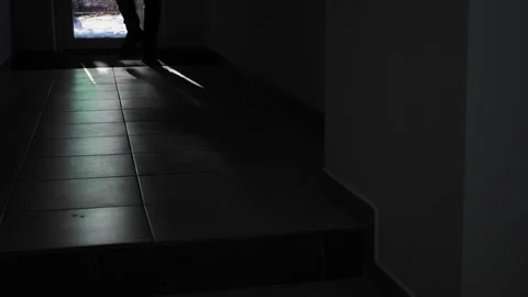 Man's legs walking towards the exit of the room along narrow corridor  Stock-Footage 263457531