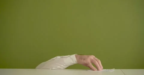 The man's mini picks up a sheet where it is written Succes Stock Footage 267090645