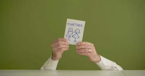 The man's mini picks up a sheet where it is written Toghether Stock Footage 267091190