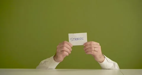 The man's mini picks up a sheet where it is written Stress Stock Footage 267091199