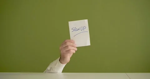 The man's mini picks up a sheet where it is written Sign Up Stock Footage 267091311