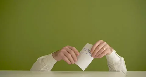 The man's mini picks up a sheet where it is written Start Stock Footage 267092019