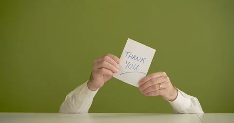The man's mini picks up a sheet where it is written Thank You Stock Footage 267092143
