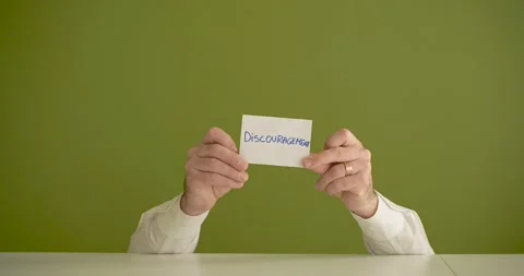 The man's mini picks up a sheet where it is written Discuragement Stock Footage 267092190
