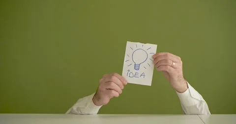 The man's mini picks up a sheet where it is written IDEEA Stock Footage 267092710