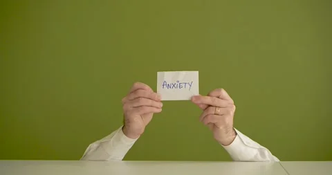 The man's mini picks up a sheet where it is written Anxiety Stock Footage 267092948
