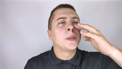 The man's nose started bleeding. High blood pressure caused blood vessels to rup Stock Footage 139202338