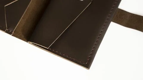 Man's open handmade dark brown genuine leather wallets on a white background Stock Photos