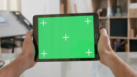 Mans point of view holding a tablet with green screen on Stock Footage 105705894