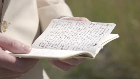 A man's reading is wedding vows in a grassy field Stock Footage 149211643