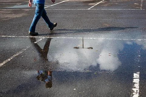 Mans reflection in puddle Stock Photos