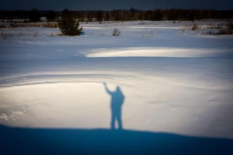 Man's shadow on snow Stock Photos