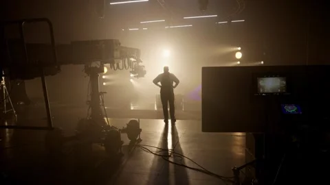 Man's Silhouette on a Dramatically Lit Studio Set in Fog Stock Footage 316761530