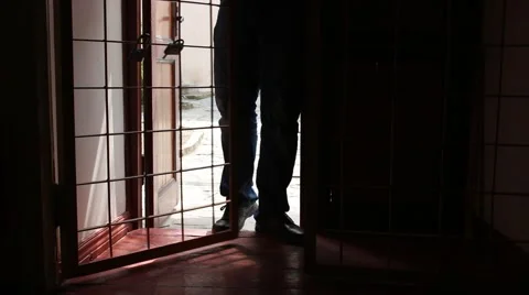 Man's silhouette is locking cell door in the jail for the prisoner 스톡 동영상 49642677