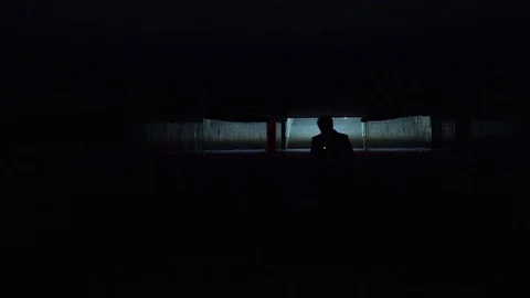 Man's silhouette walks through underground crossing Видео 81595582