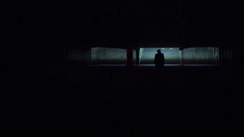 Man's silhouette walks through underground crossing Видео 81595623