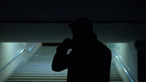 Man's silhouette walks through underground crossing Видео 81595749