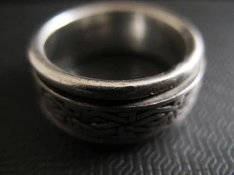 Man`s silver ring on futuristic surface. Vintage style. Focus on front view. Stock Photos