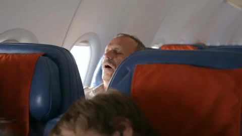 Mans sleeping in the airplane Stock Footage 96037212