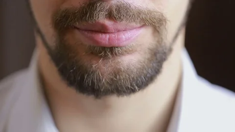 The man's smile.A man with a beard smiling. Close-up. sexy lips Stock Footage 70950413