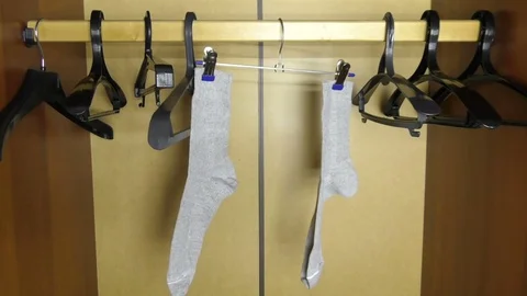 A man's socks hang into an empty wardrobe Stock Footage 80883881