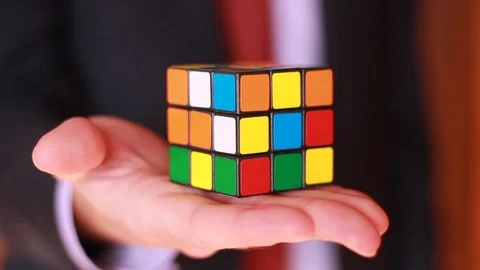 Man's stretched hand with Rubik's cube closeup Stock Footage 99441827