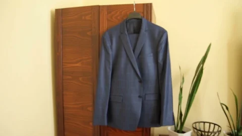 Man's suit hangs on the closet in the interior of the room. wedding day 動画素材 80488006