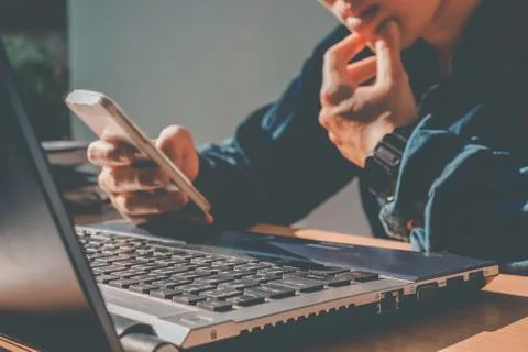 Man's using laptop with blank screen on desk in home interior. Business conce Stock Photos