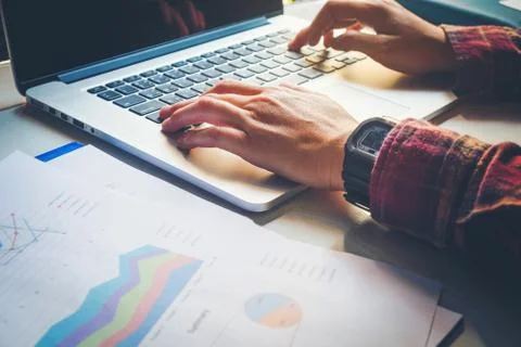 Man's using laptop with blank screen on desk in home interior. Business conce Stock Photos