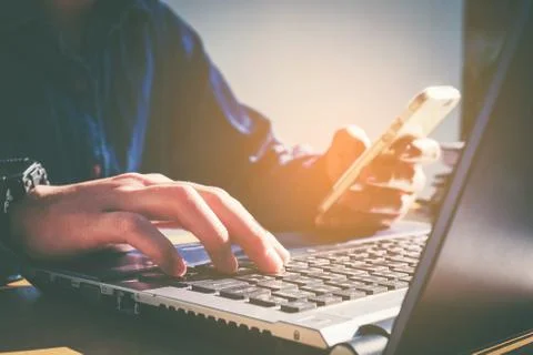 Man's using laptop with blank screen on desk in home interior. Business conce Foto stock
