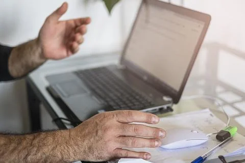 A man's using laptop hand on mouse and shows the screen Stock Photos