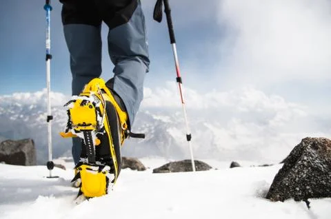 Mans walking with crampons Stock Photos
