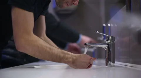 A mans washes his hands and face. Slow motion Stock Footage 47897514