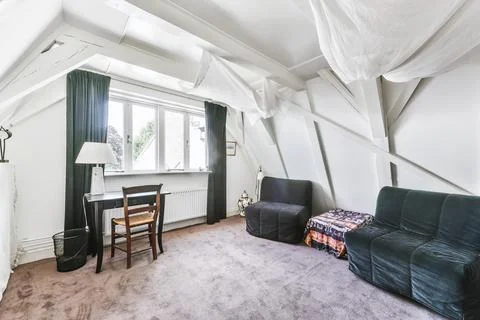 Mansard room with beamed ceiling Stock Photos