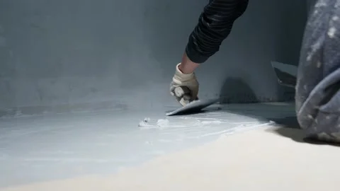 Manual application of waterproofing on the floor on the construction site Stock Footage 231776317