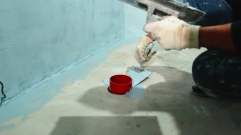 Manual application of waterproofing to the wall on the construction site Stock Footage 231432438