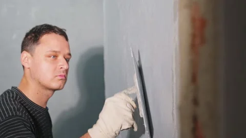 Manual application of waterproofing to the wall on the construction site Stock Footage 231432451