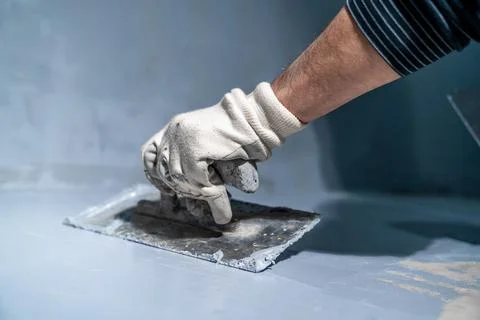 Manual application of waterproofing to the wall on the construction site Stock-Fotos
