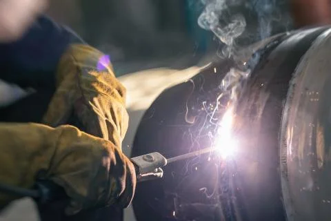 Manual arc welding of large diameter pipeline elements Stock Photos