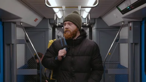 Manual camera. 4k video. Portrait of a red-bearded courier in the subway Stock Footage 236089720